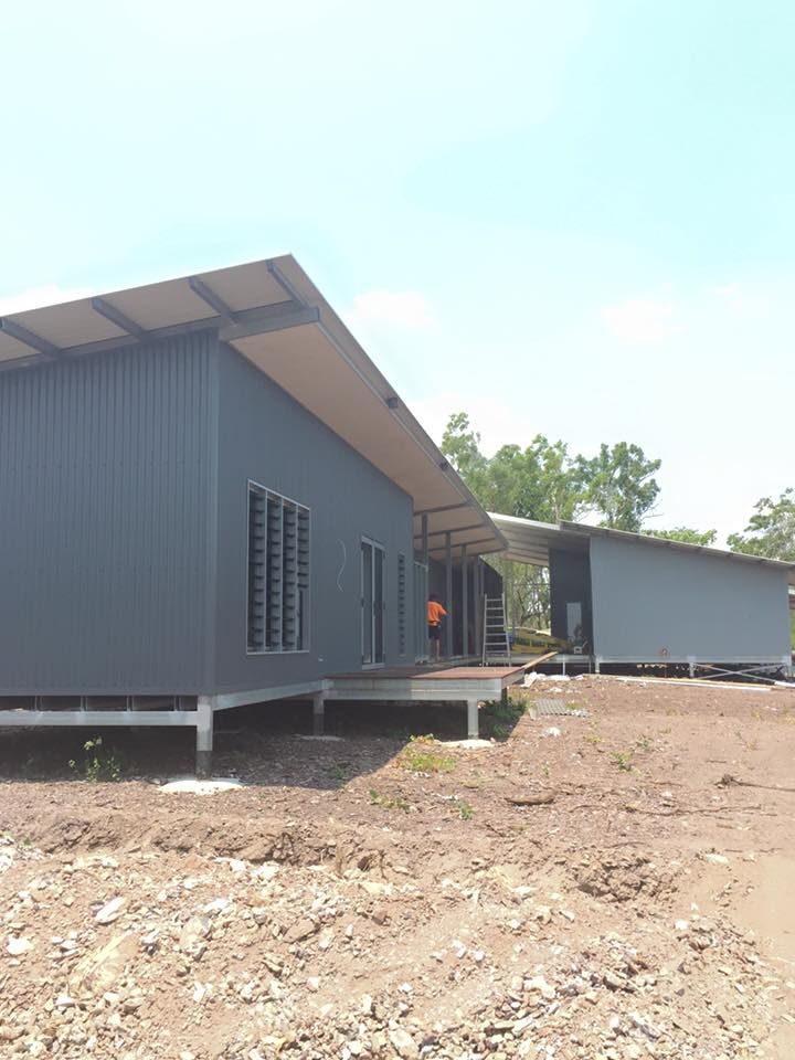 A Couple Of Houses Are Sitting On Top Of A Dirt Field — SLS Builders Pty Ltd in Katherine, NT