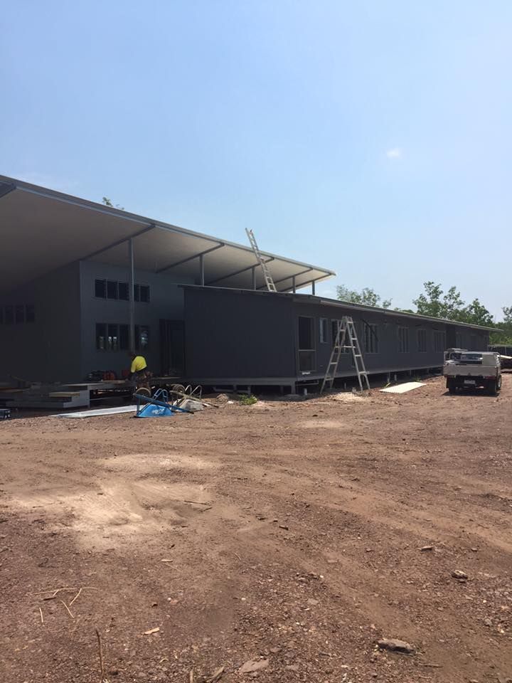 A Large Building is Being Built in a Dirt Field — SLS Builders Pty Ltd in Humpty Doo, NT