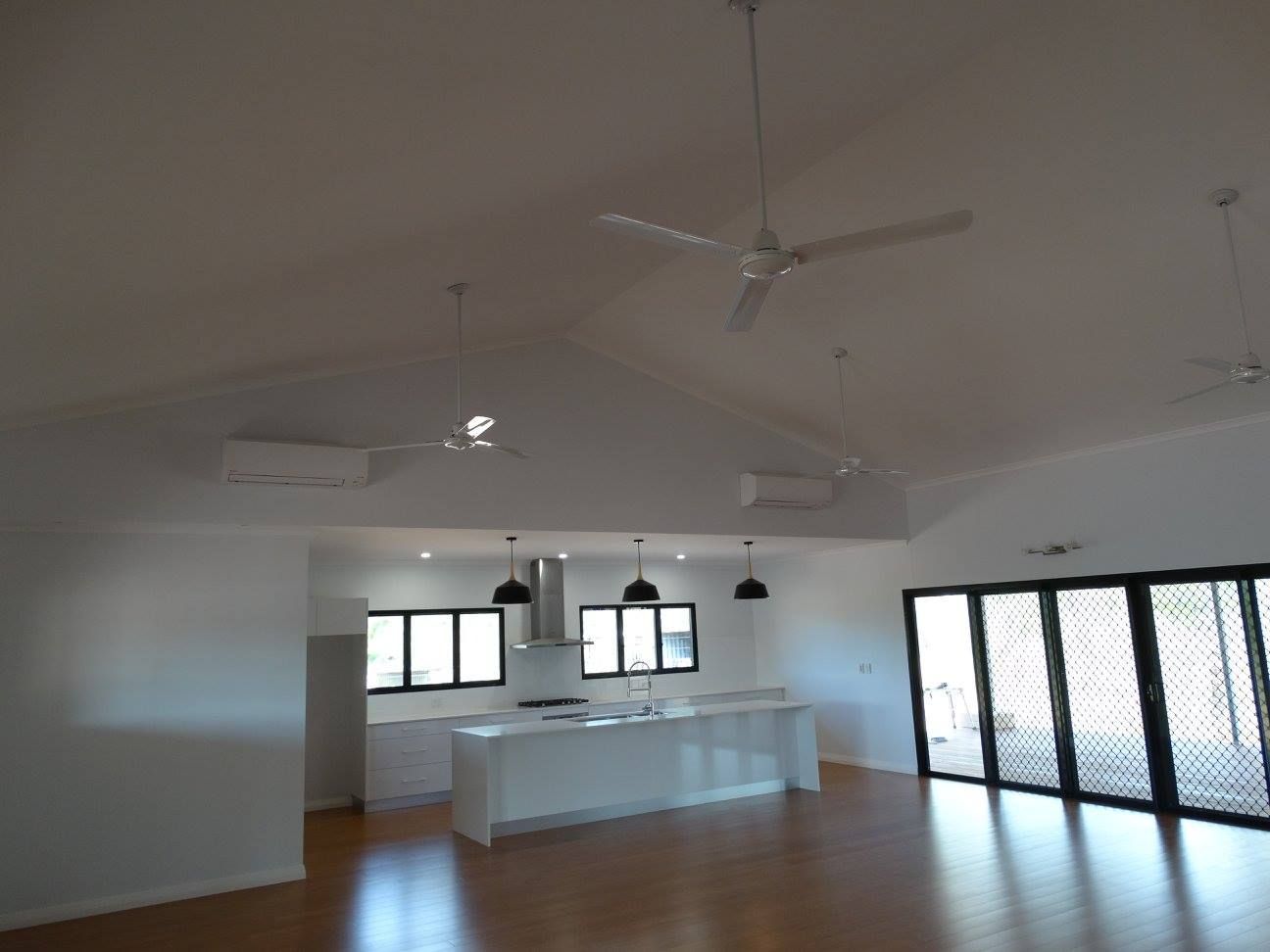 An Empty Kitchen With A Ceiling Fan Hanging From The Ceiling — SLS Builders Pty Ltd in Humpty Doo, NT
