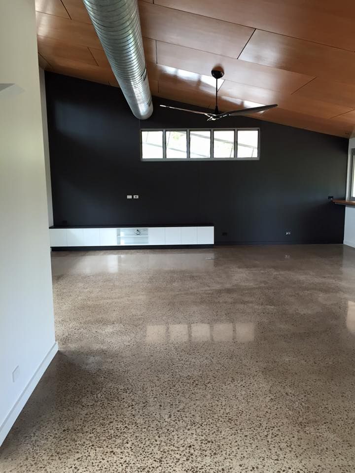 An Empty Room With A Ceiling Fan And A Black Wall — SLS Builders Pty Ltd in Humpty Doo, NT