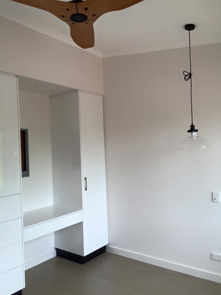 An Empty Room With A Ceiling Fan And A Light Hanging From The Ceiling — SLS Builders Pty Ltd in Humpty Doo, NT