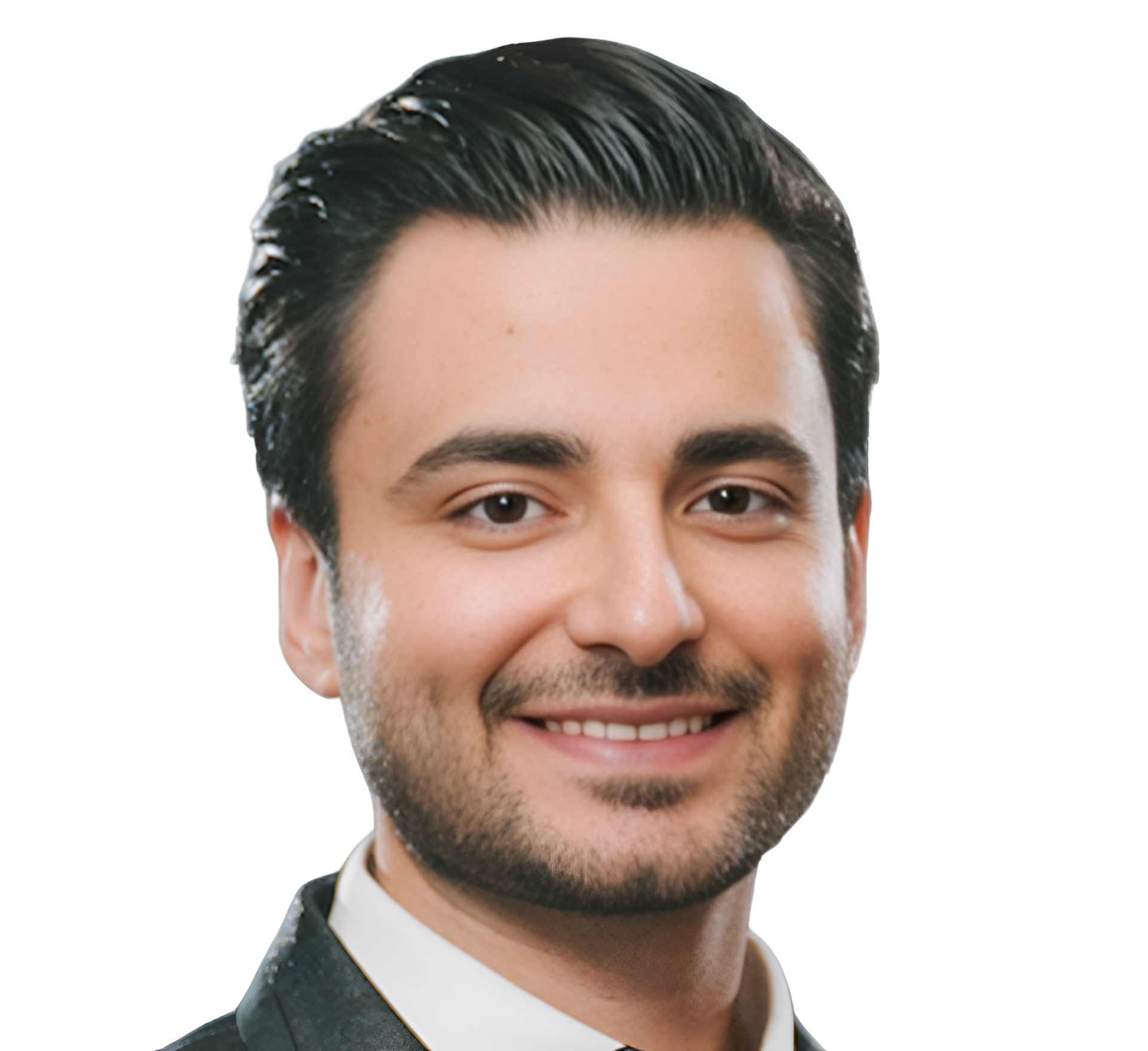 Man with dark hair and a beard smiles at the camera. He is wearing a dark suit with a white shirt.