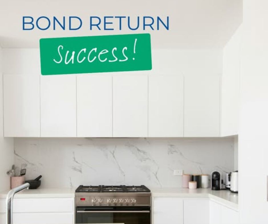 BOND RETURN success sign above a modern white kitchen with marble backsplash and stove BOND RETURN success sign above a modern white kitchen with marble backsplash and stove