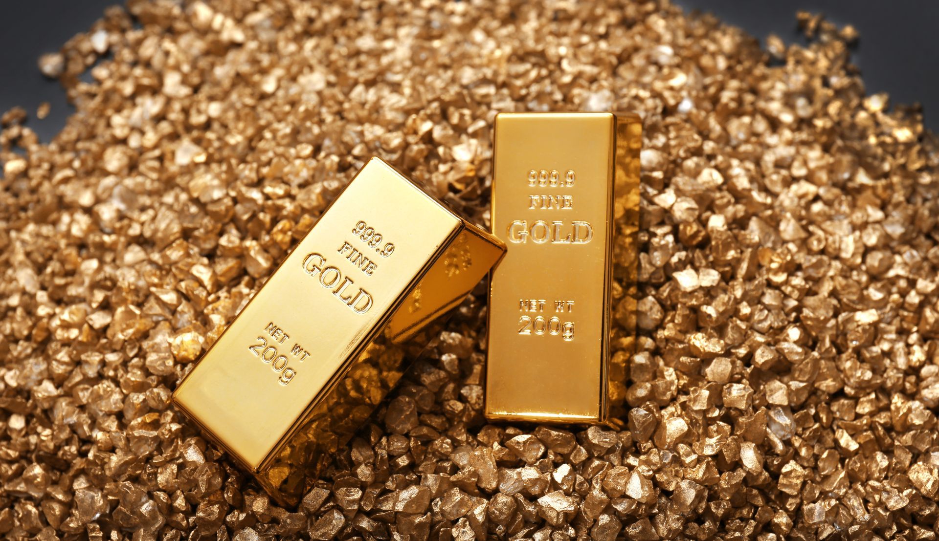 two gold bars resting on a pile of small gold nuggets. Labeled