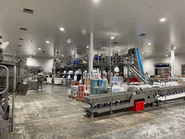 Large industrial food packaging facility with machinery and supplies.