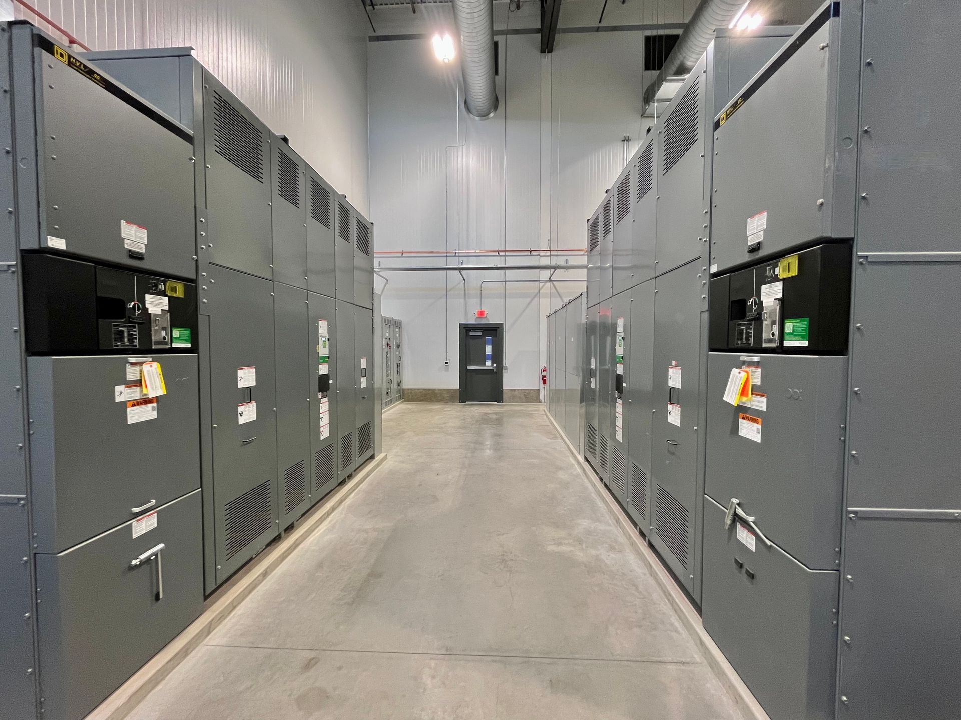 Rows of gray electrical panels in a utility room.