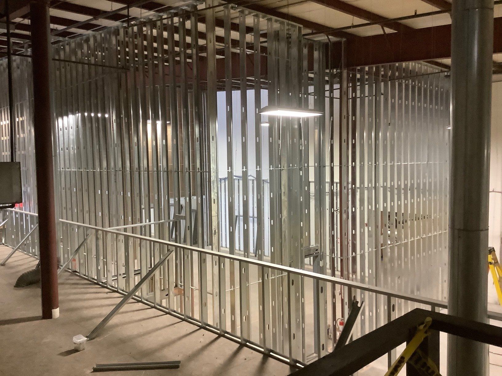 Steel stud framing for interior walls under construction in a building.