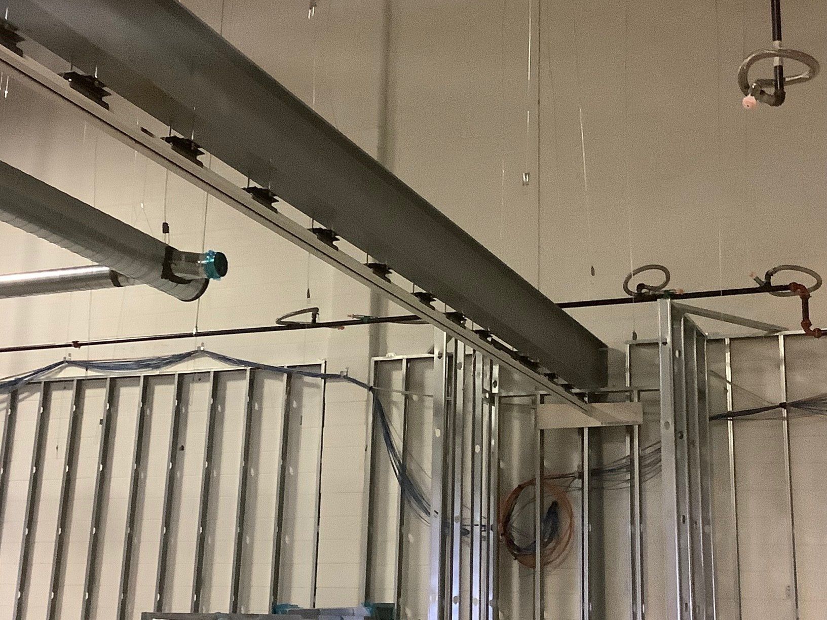 Steel beams and studs in a construction setting, likely for a commercial building.