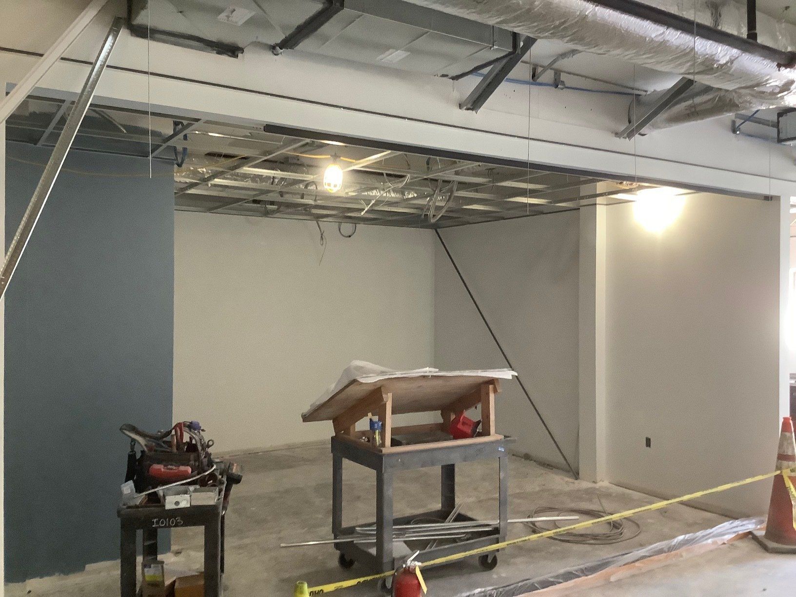 Interior construction with exposed ceiling supports, unfinished walls, and equipment.