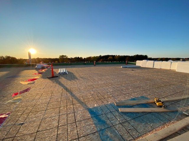 Construction site, rebar grid prepared for concrete pour, at sunset.