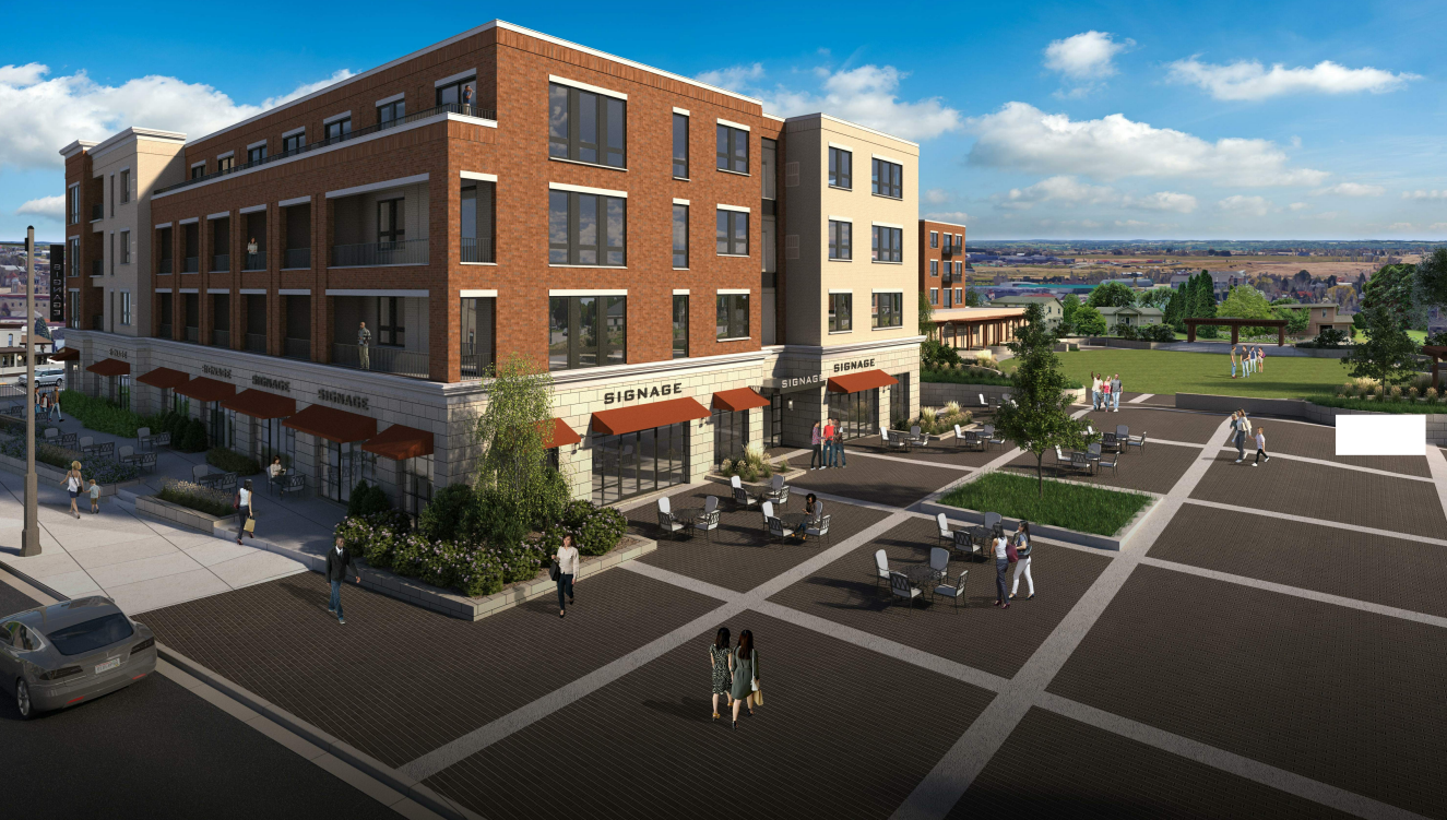Multi-story brick building with shops on the ground floor, outdoor seating, and a public square.