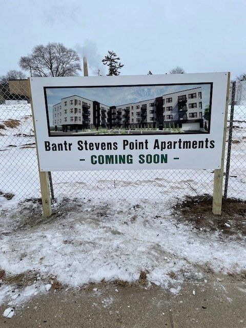 Sign for Bantr Stevens Point Apartments, showing building rendering, 