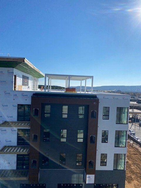 A multi-story building under construction with a clear blue sky above.