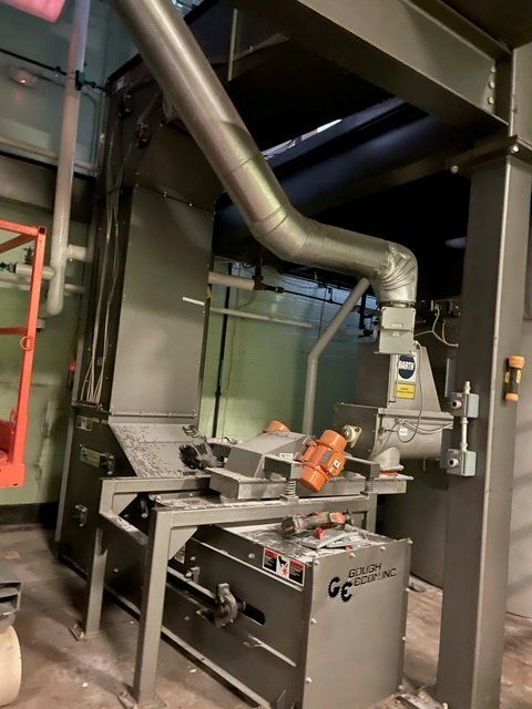 Industrial machinery with ductwork, stainless steel, and orange motors.