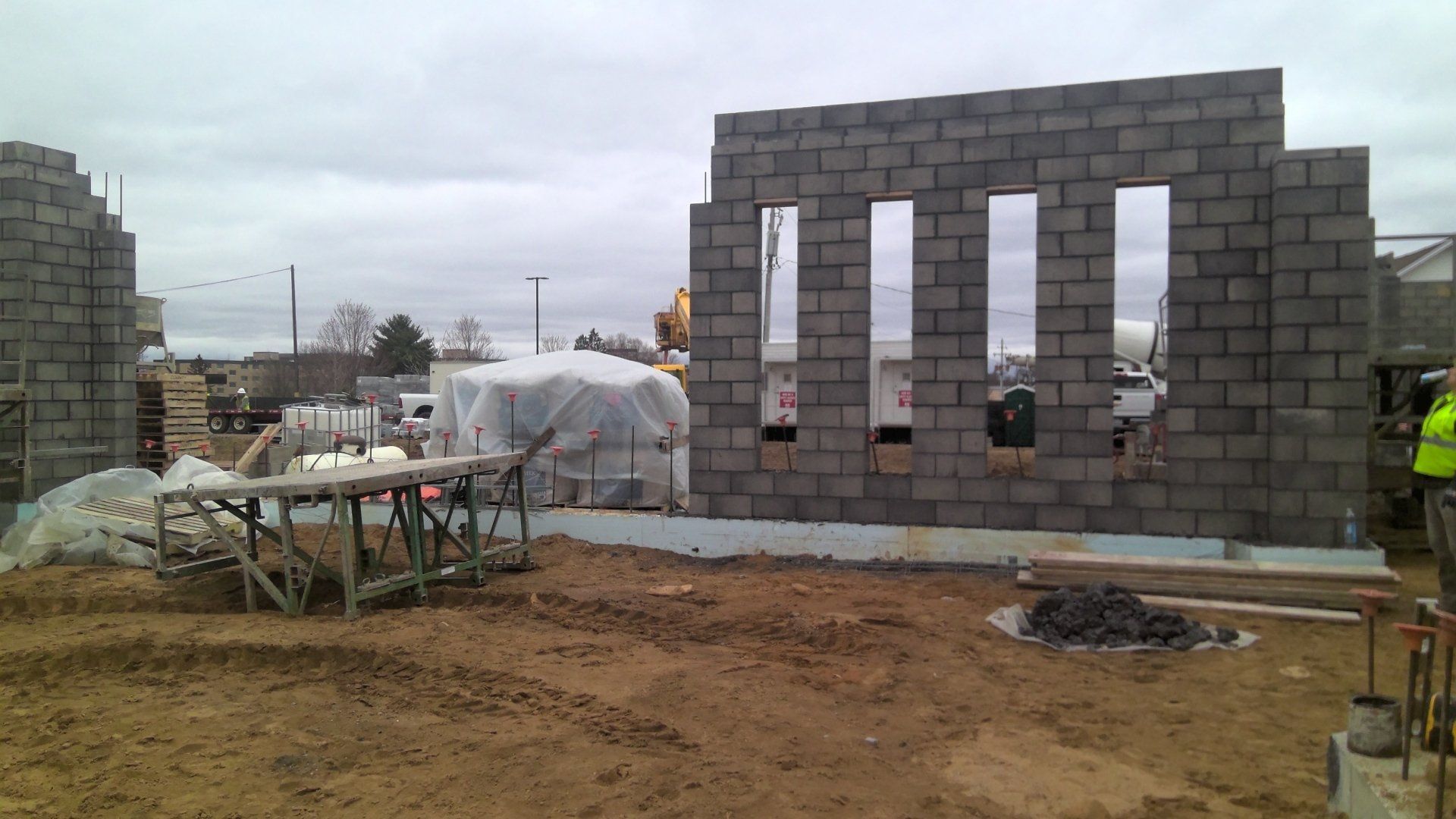 Construction site with unfinished gray concrete block walls.