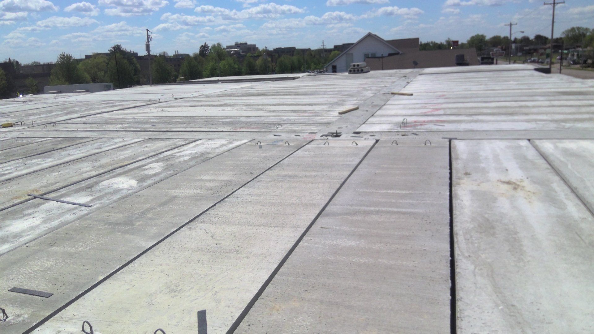 Precast concrete slabs laid out, ready for installation. Outdoors, sunny day.