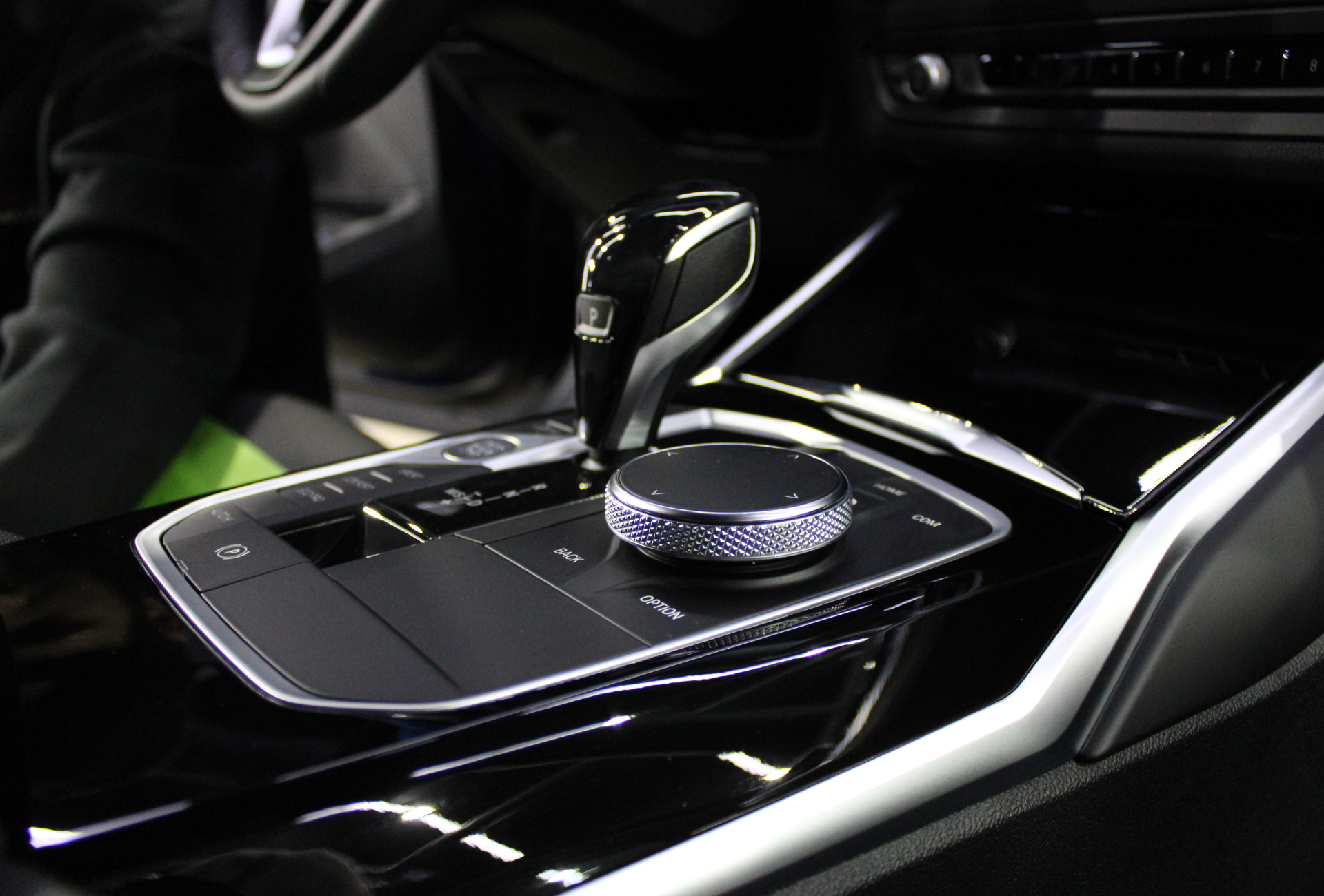 A close up of a car dashboard with a shifter