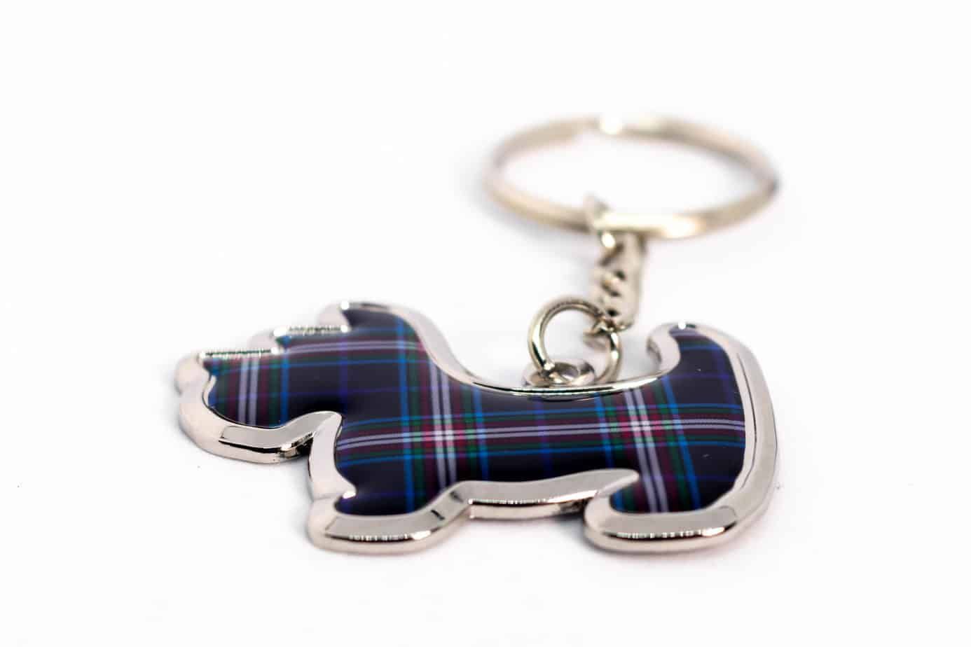 Keychain in the shape of a Scottish terrier, featuring blue and red plaid pattern, on a white background.
