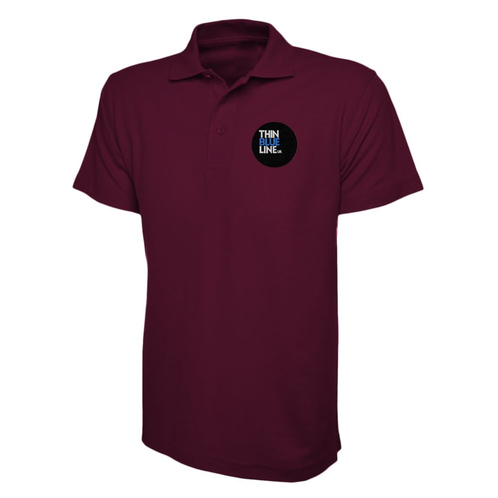 Green polo shirt with a black circular logo that says 