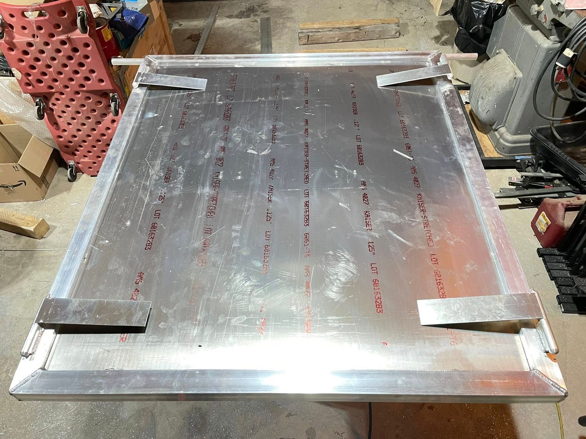 A piece of metal is sitting on a table in a garage.