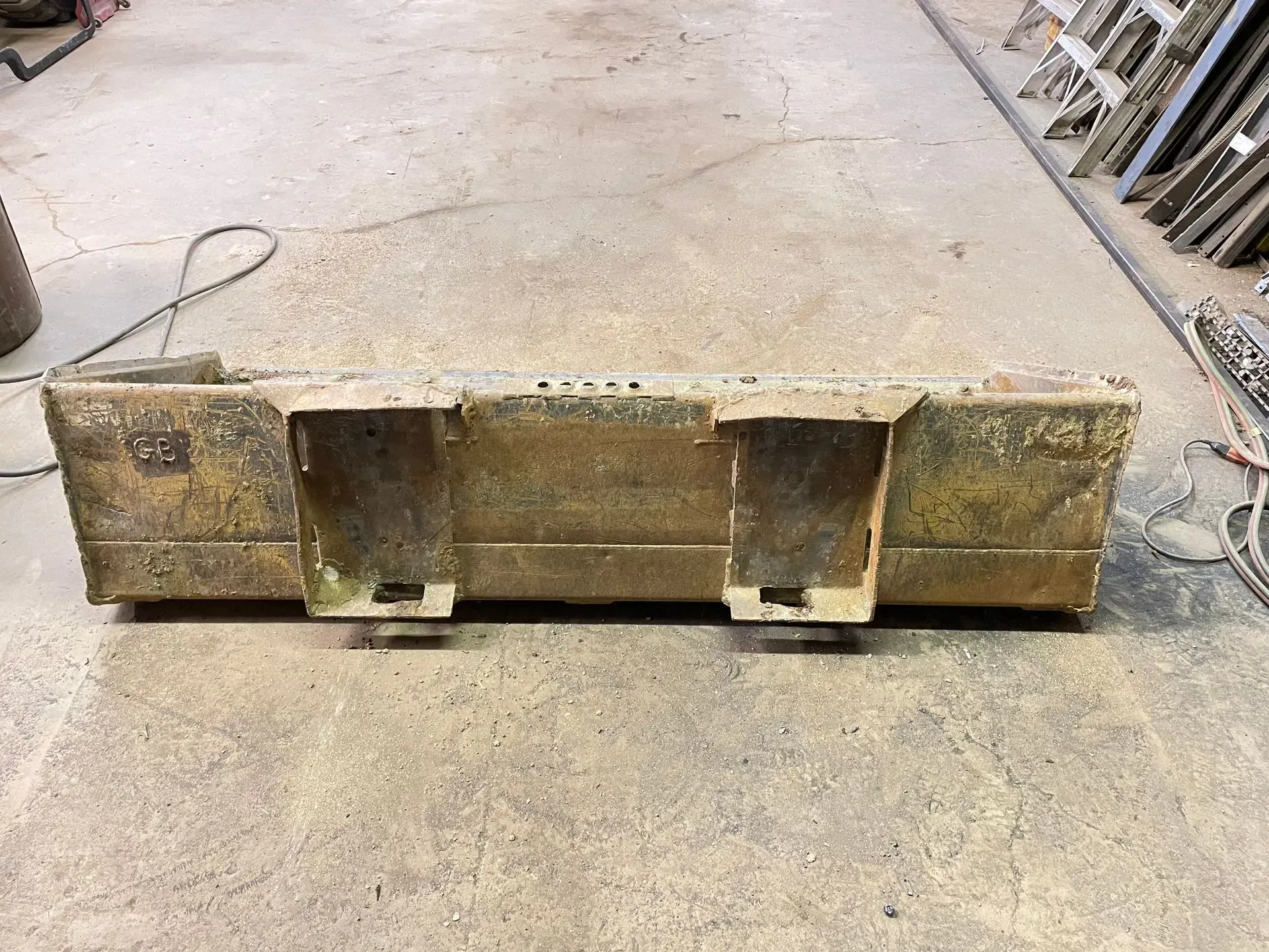A piece of wood is sitting on top of a concrete floor.