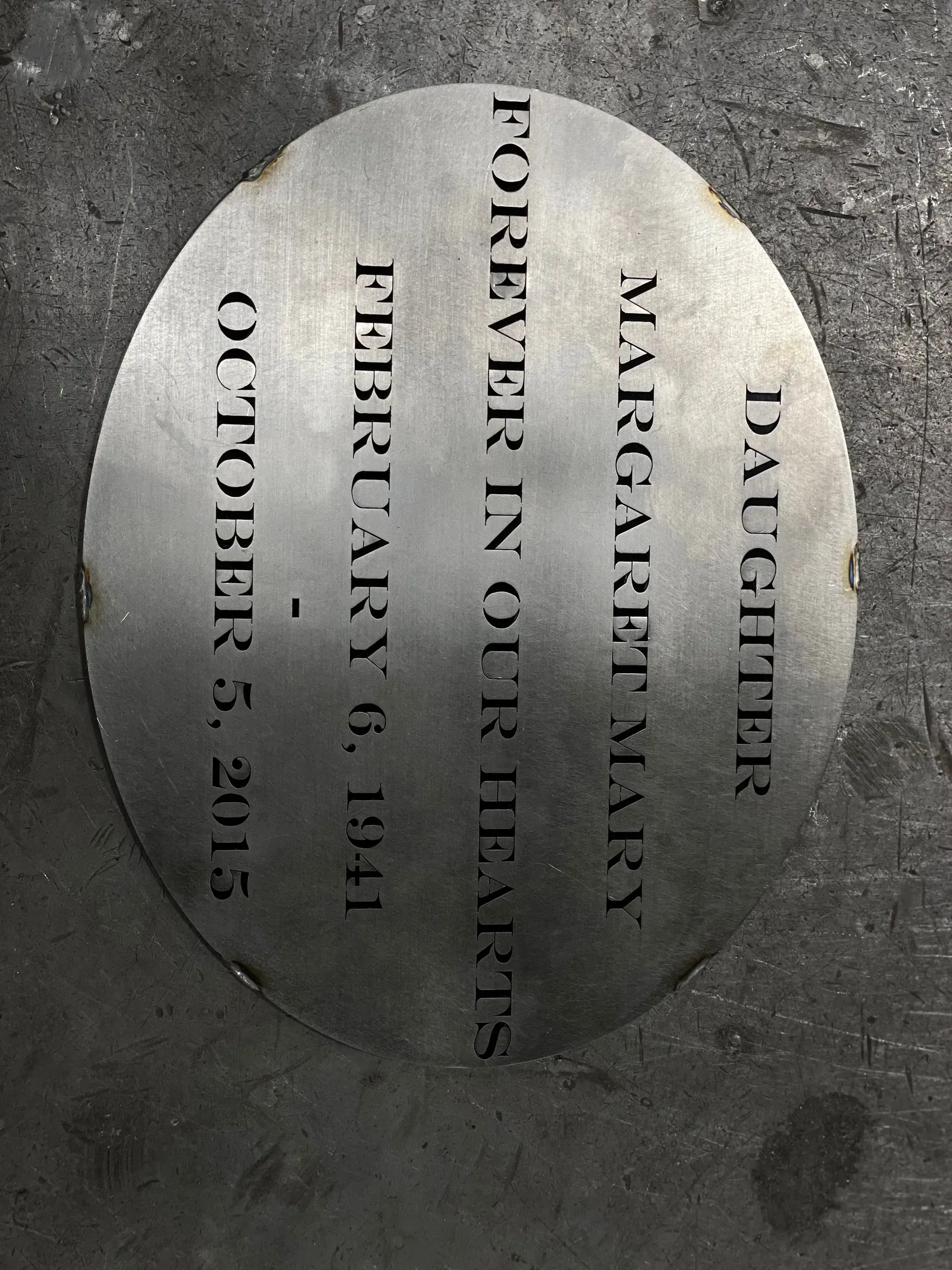 A plaque that says margaret mary forever in our hearts