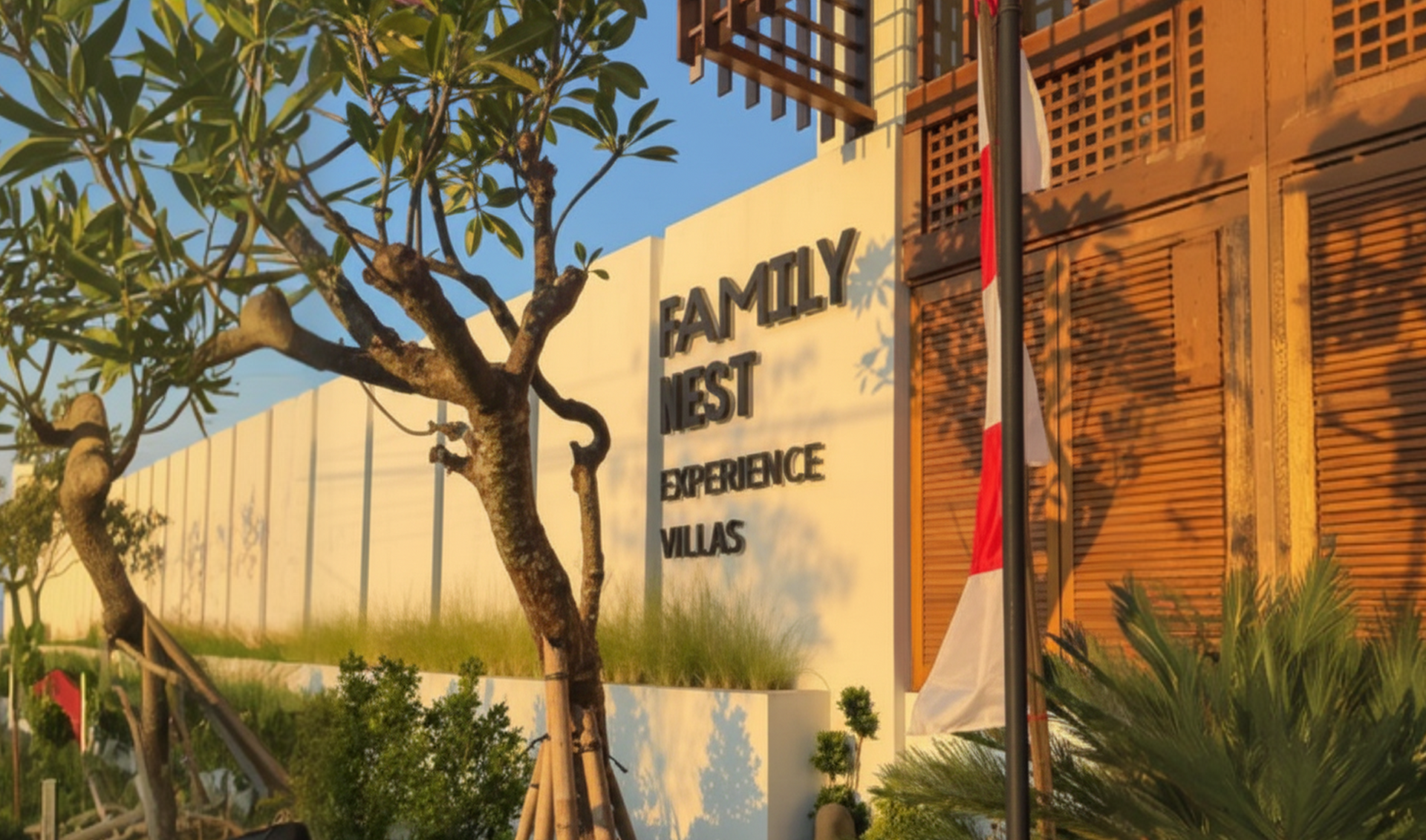 Sign for Family First Residence beside a tree and orange wall in warm sunlight