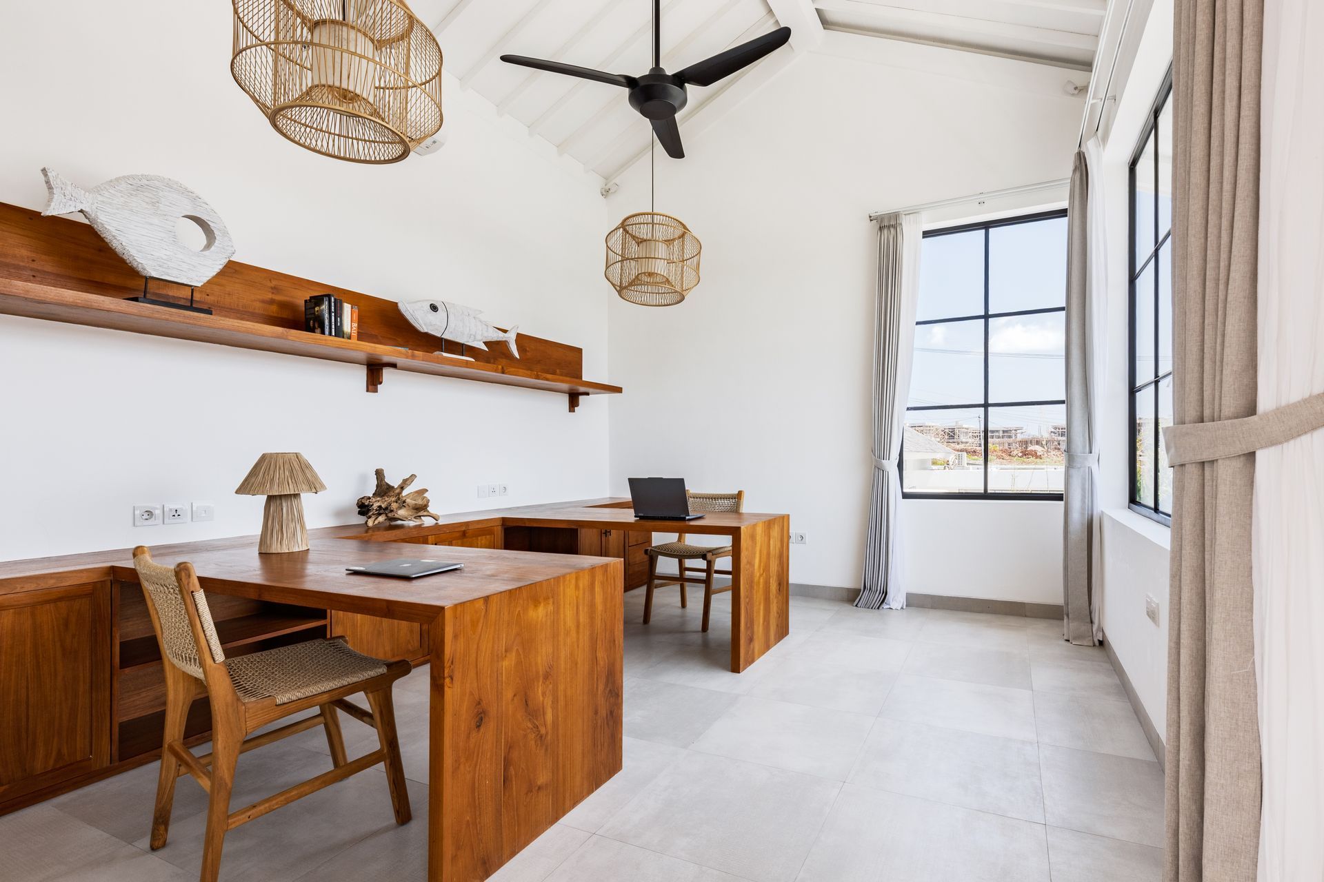Bright minimalist dining room with wooden table, chairs, shelves, and ceiling fan by large windows