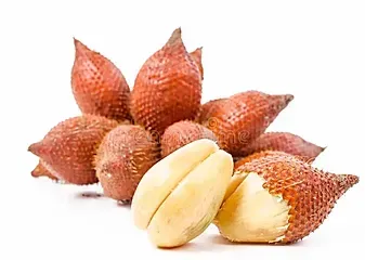 Cluster of red snake fruit with one peeled fruit in front, showing pale yellow flesh