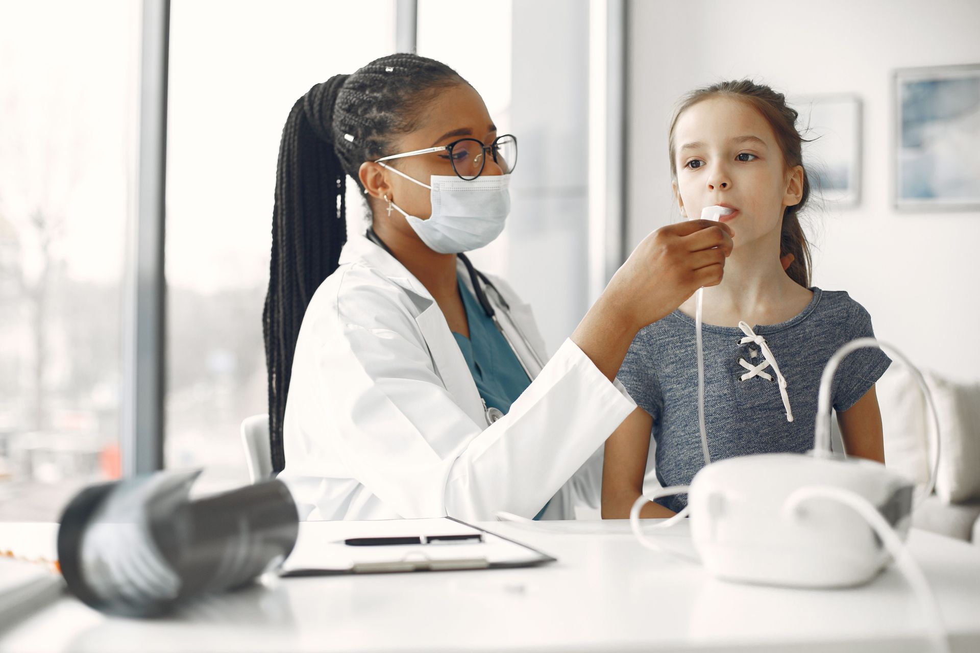 Doctor examining a child’s throat in a bright clinic