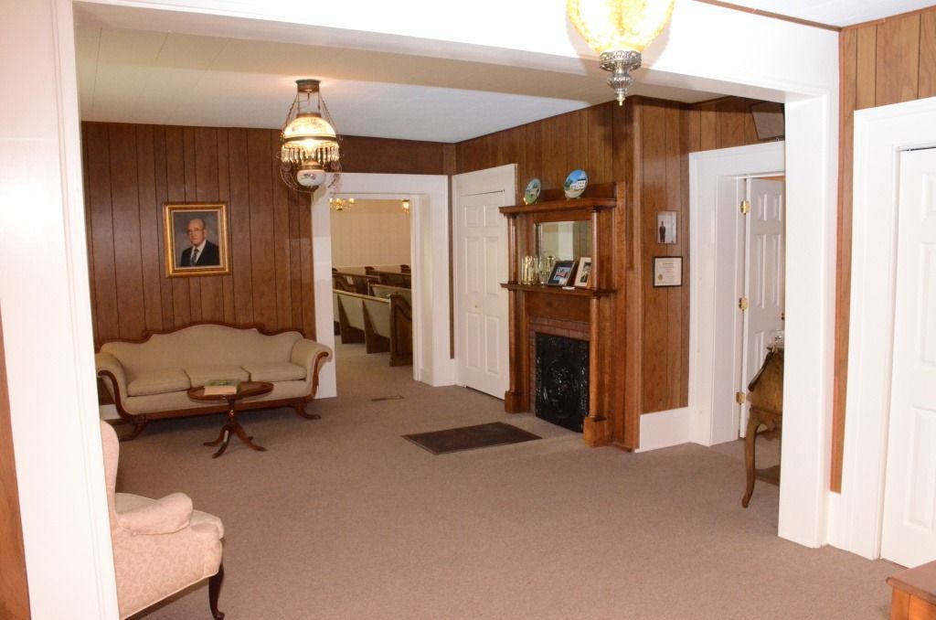 funeral home lobby with couch and fireplace