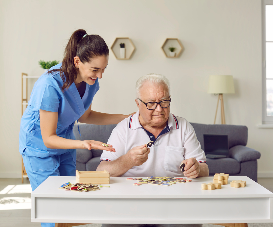 Caregiver assisting a person with puzzle in a home setting.