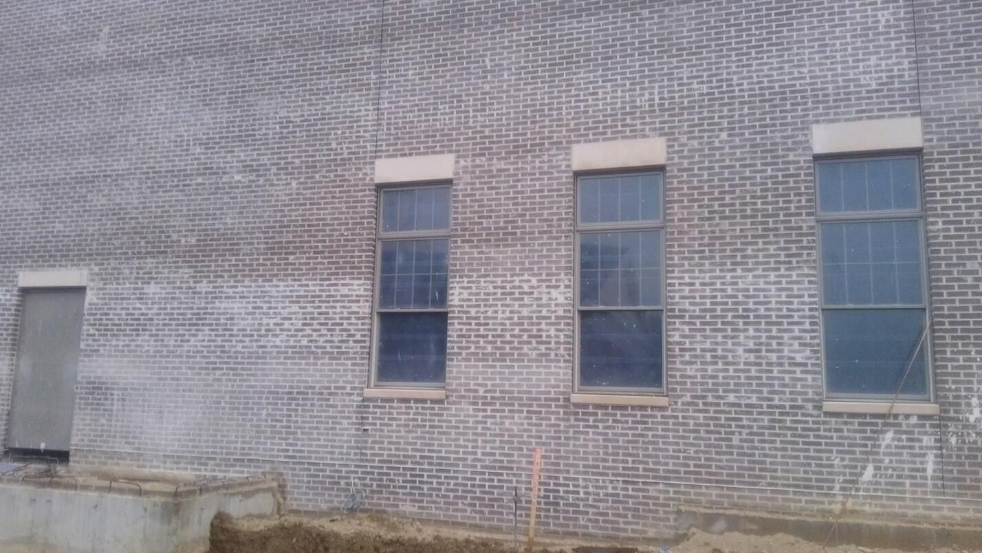 Photo of a new building that has construction dust all over it and needs new concrete