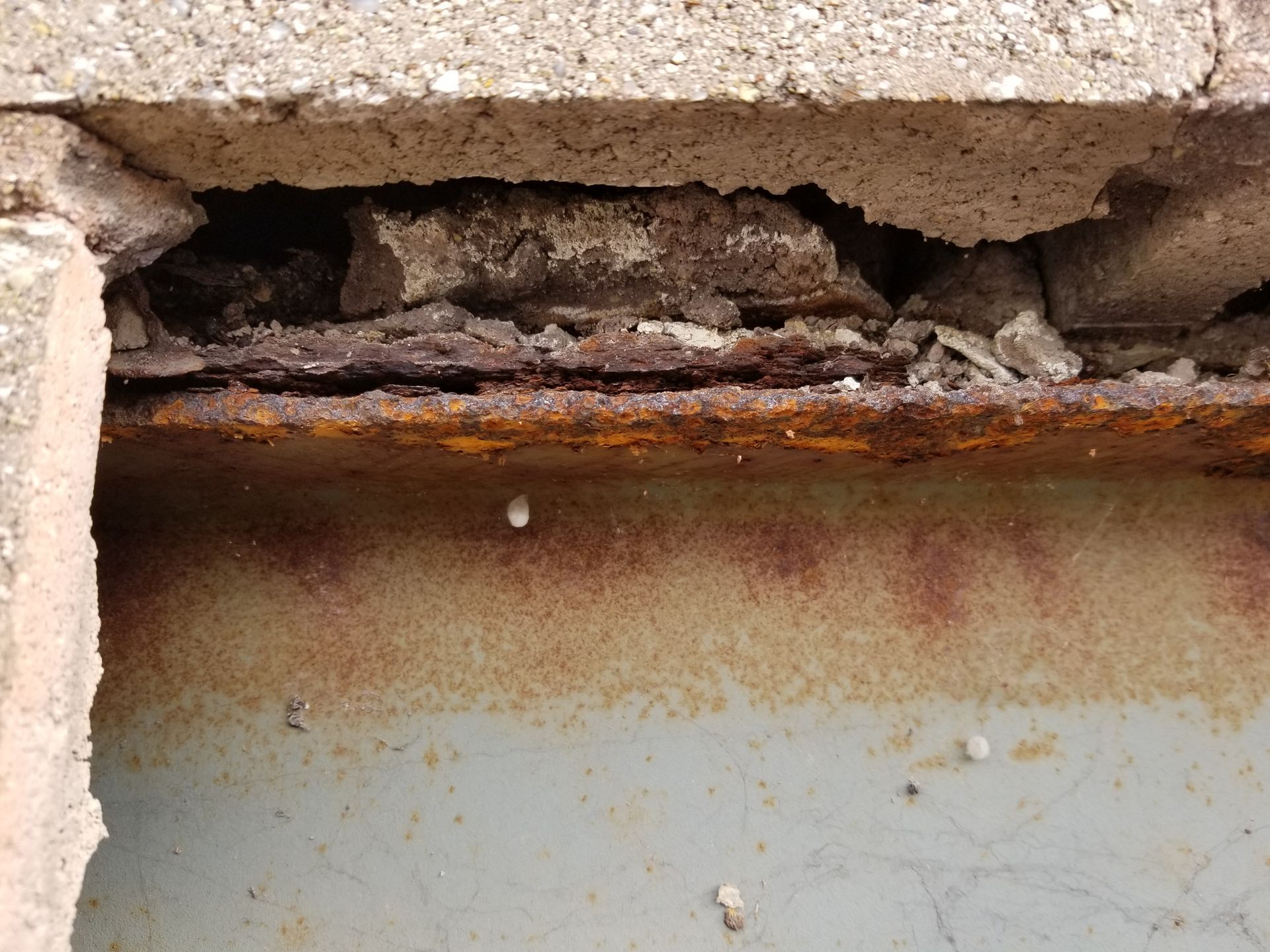 Rusted I-beam due to one small crack in the stone wall