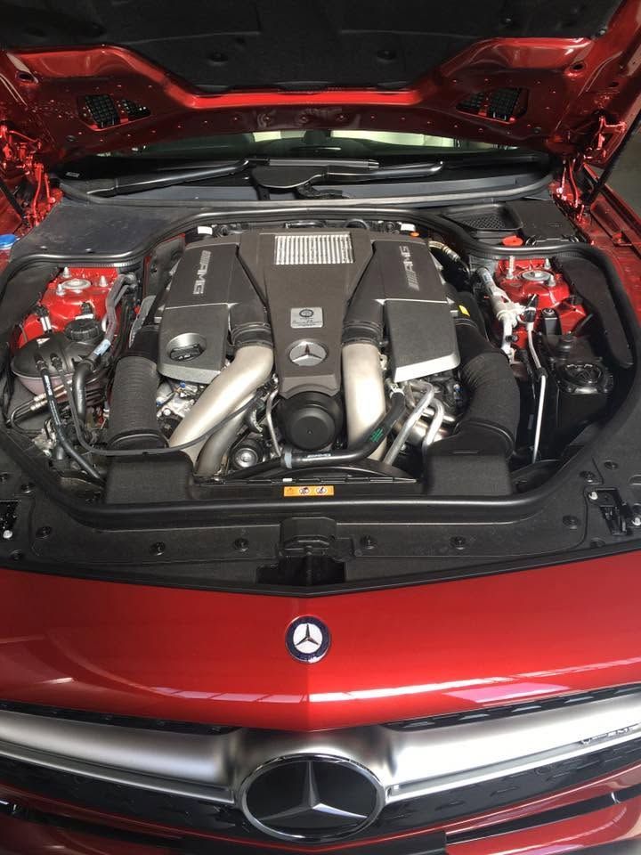 Open red Mercedes-Benz engine bay with V8 engine and hood open