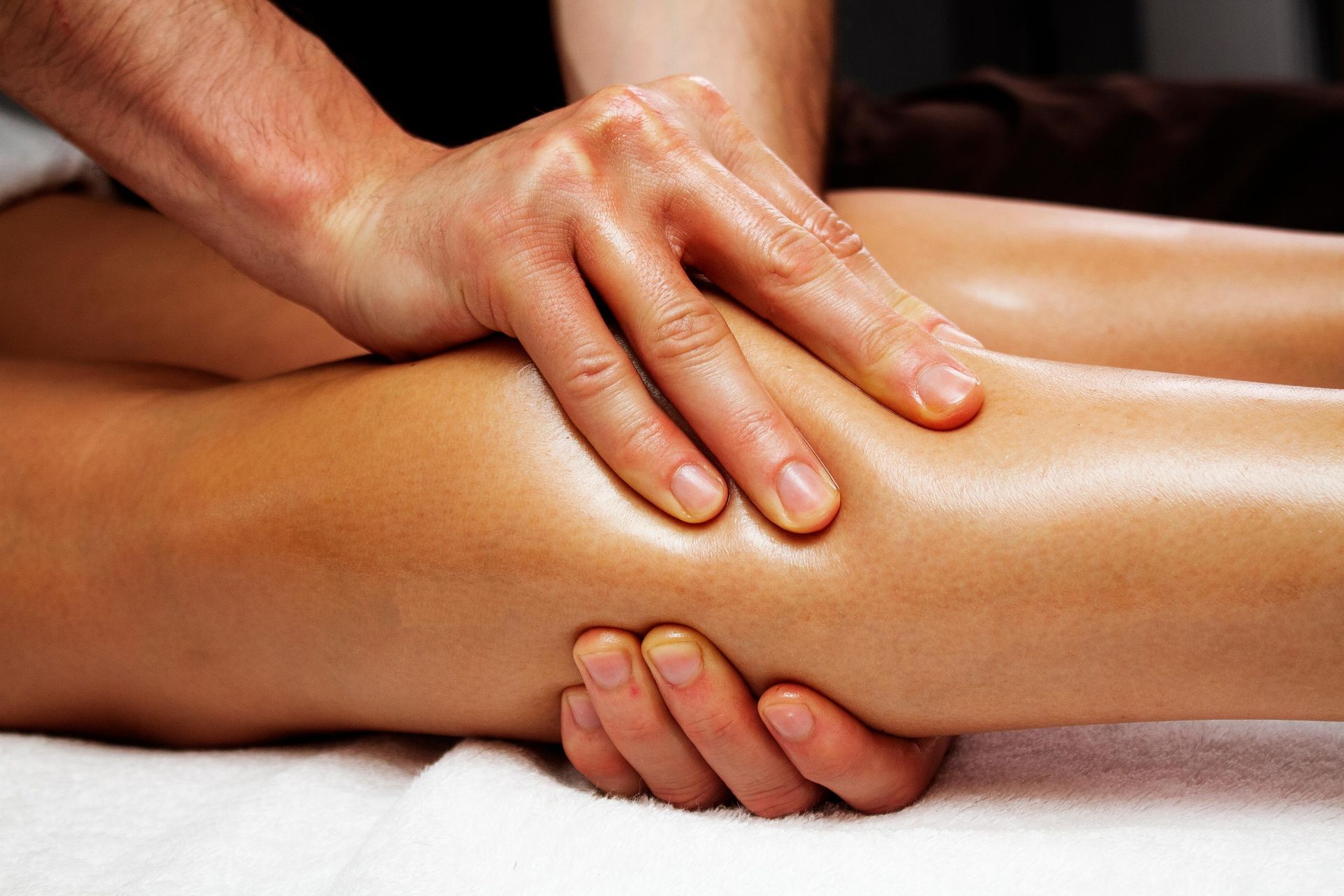 a woman is getting a massage on her leg in a spa .