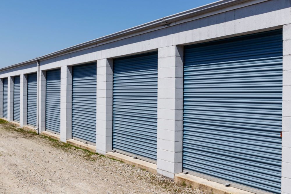 A Row of Storage Units With Blue Doors on a Sunny Day — Bellarine Removals In Altona, VIC