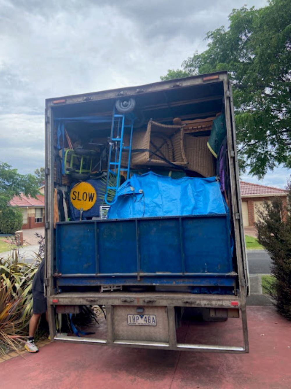 A Moving Truck is Filled With Furniture and a Blue Tarp — Bellarine Removals In Bellarine Peninsula, VIC