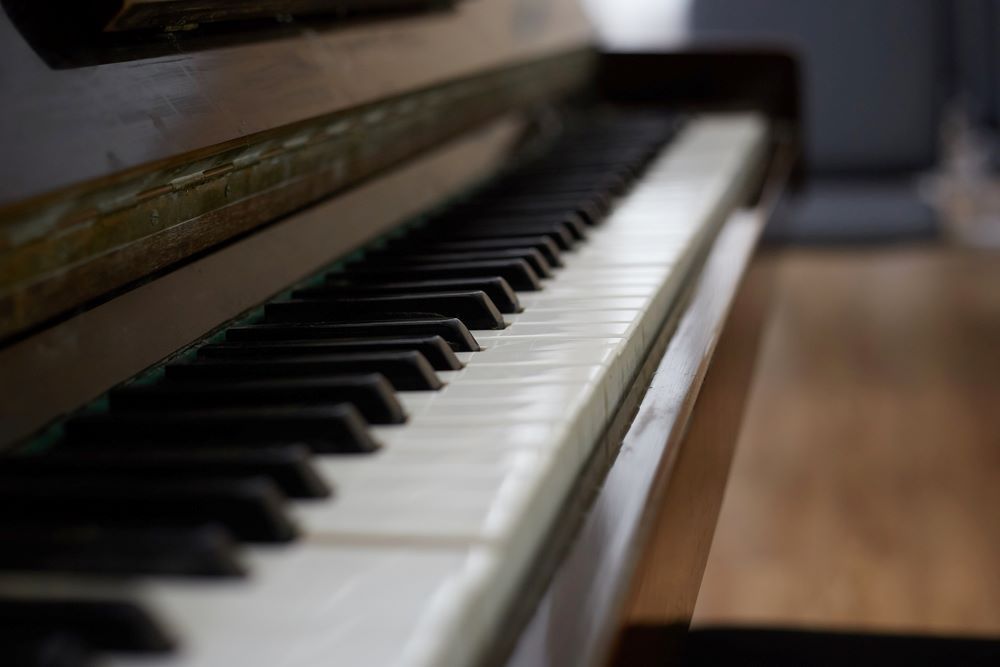 A Close Up of a Piano Keyboard on a Wooden Floor — Bellarine Removals In Colac, VIC
