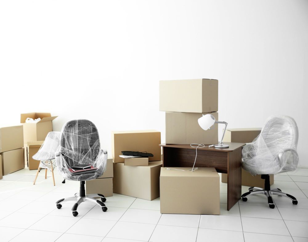 A Room Filled With Boxes, Chairs, a Desk and a Lamp — Bellarine Removals In Geelong, VIC