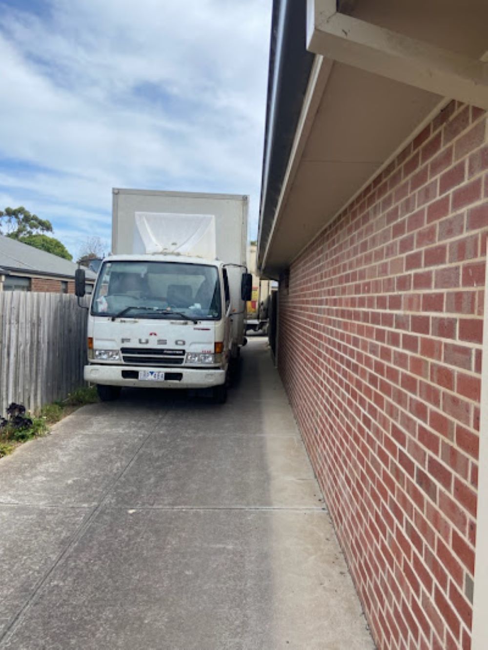 A White Truck is Parked Next to a Brick Wall — Bellarine Removals In Geelong, VIC