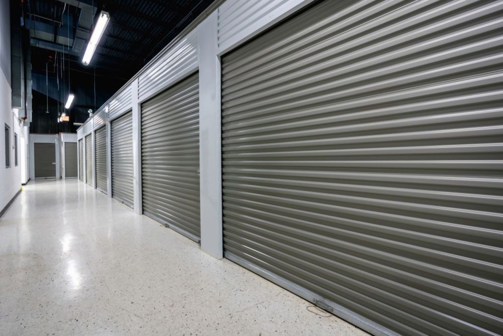 An Empty Hallway With a Row of Storage Doors — Bellarine Removals In Surf Coast, VIC
