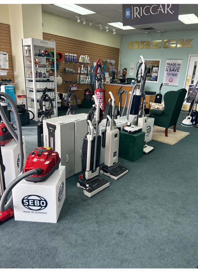 Vacuum cleaner store with various models on display.