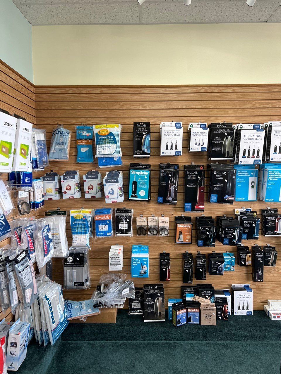Shelves stocked with hearing aid supplies displayed in a retail store setting.