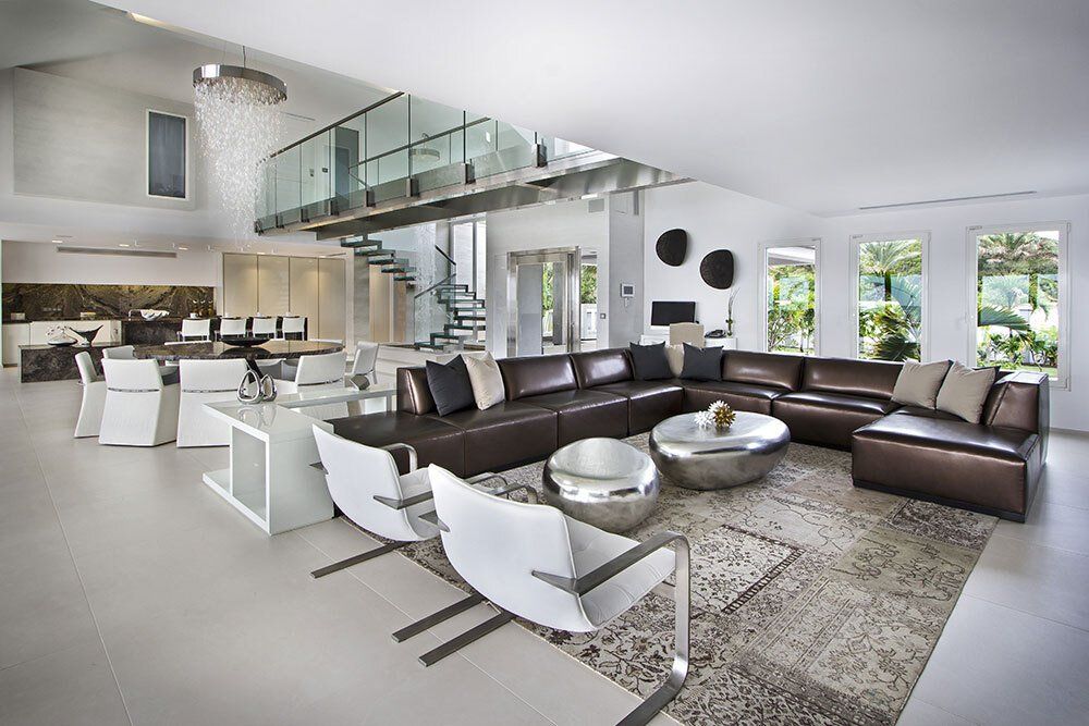 A living room filled with furniture and a staircase.