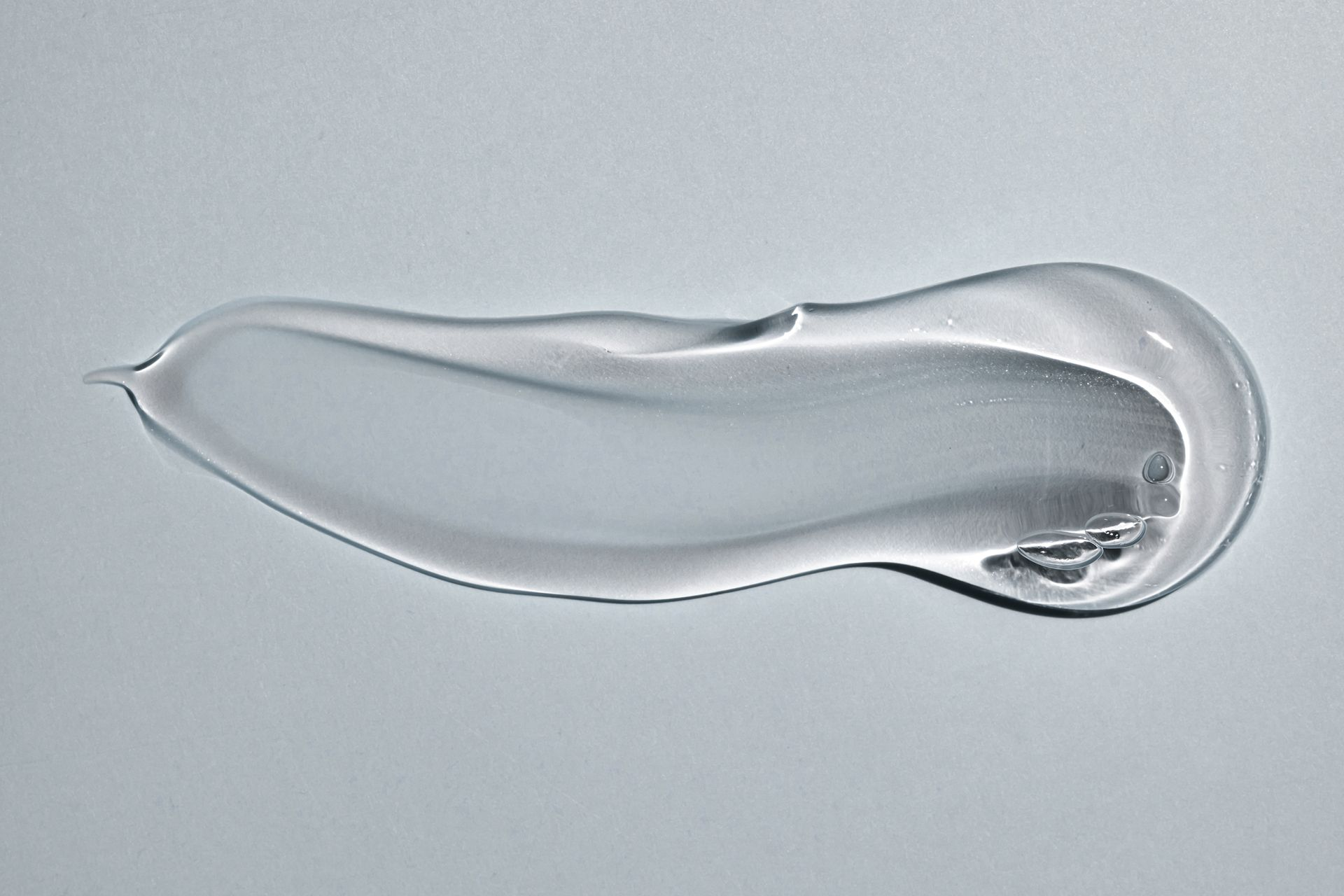 A close up of a black clay mask on a white background.