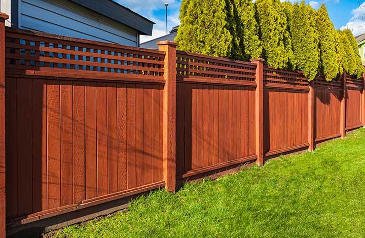 Nice new wooden fence around house.