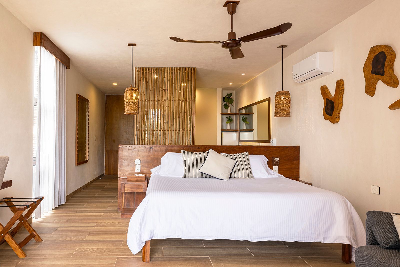 Bedroom with a bed, bamboo wall, wooden accents, and a ceiling fan.