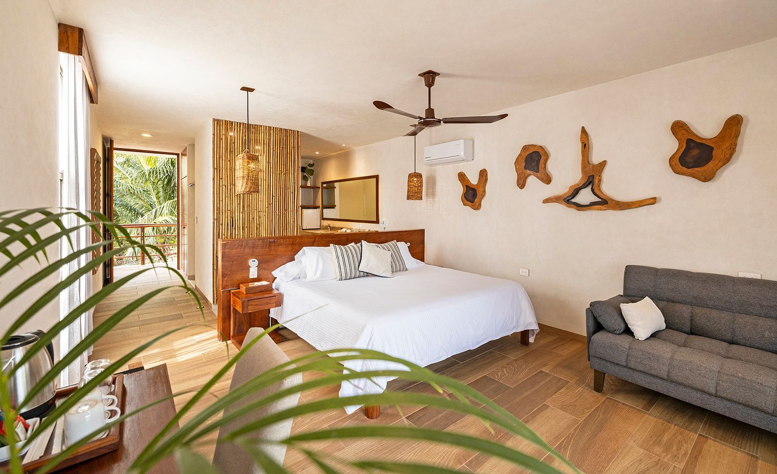 Bedroom with a bed, sofa, wood decor, and a balcony view.