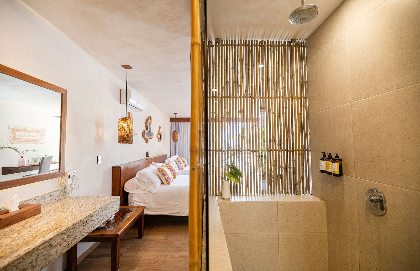 Bathroom and bedroom with natural decor, bamboo shower wall, stone vanity.